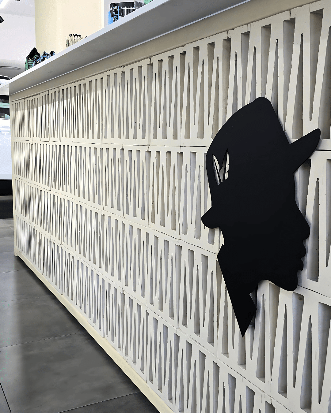 Painted white Lattice terracotta screen block used in a cafe counter.